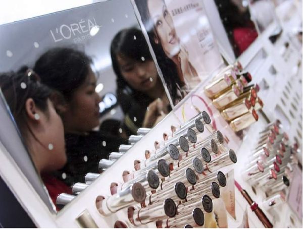 顾客在北京一家商场的欧莱雅专柜试用口红。（彭博新闻社网站）